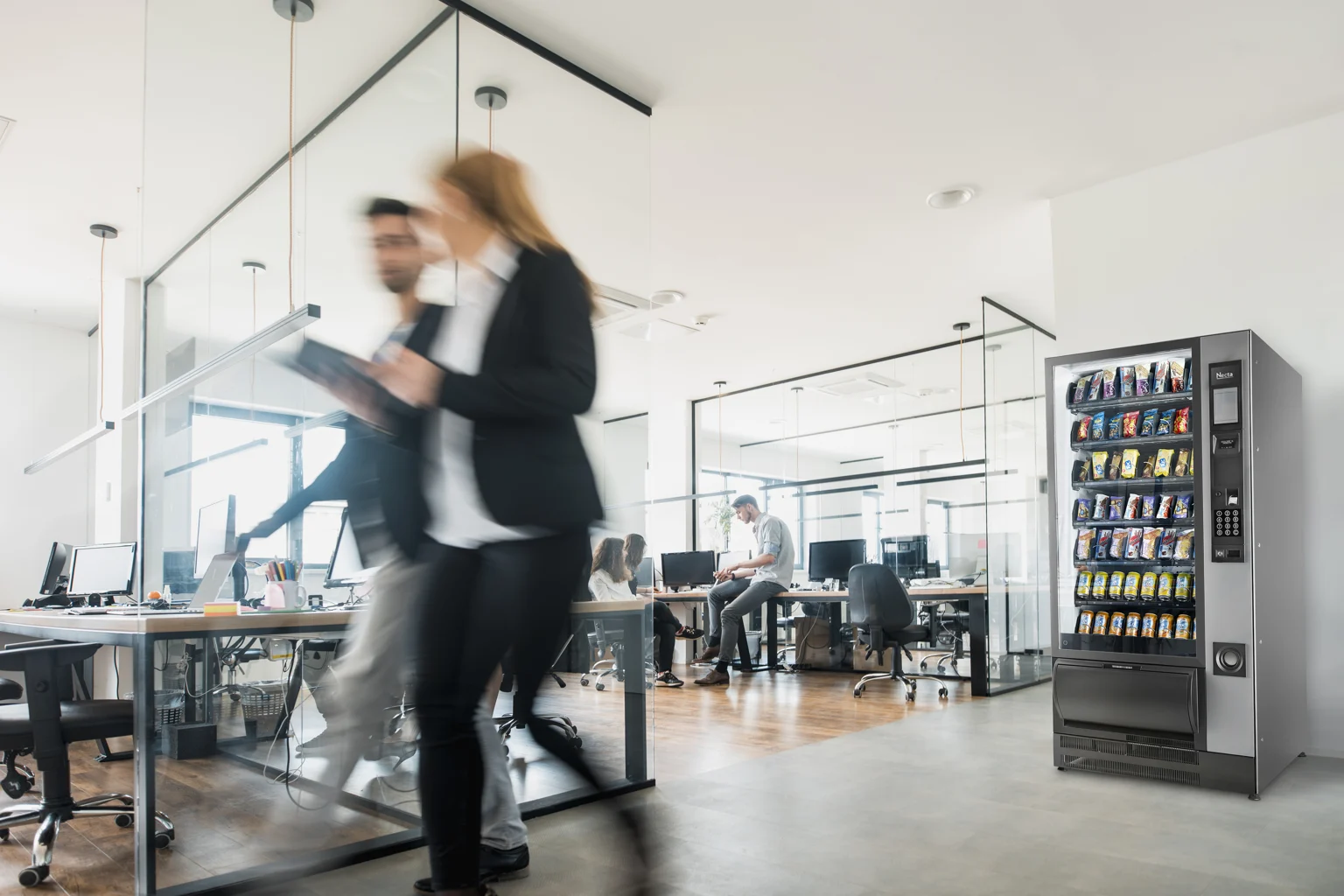 Snack and chilled drink vending machine in a bright workplace